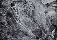 Attaching the earth wire of the generator to a water pipe, 1967, © Photo courtesy of 'Brockham Museum News' and A W Deller