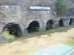 
A large bank of limekilns at Berzee, South of Charleroi, Belgium, taken at speed from the train, June 2024
